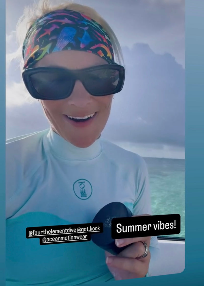 Woman wearing sunglasses and a rainbow shark headband with a scenic background, text 'Summer vibes!' displayed.