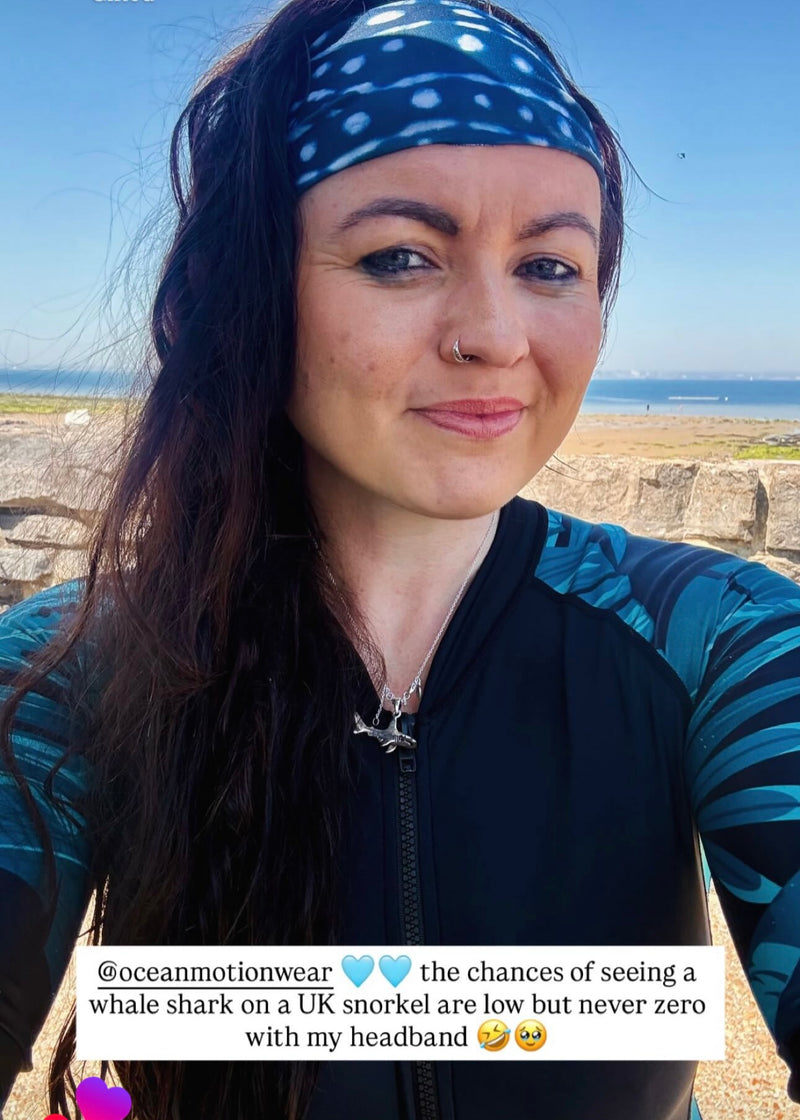 Woman wearing a blue and black patterned headband with text overlay about whale shark sightings.