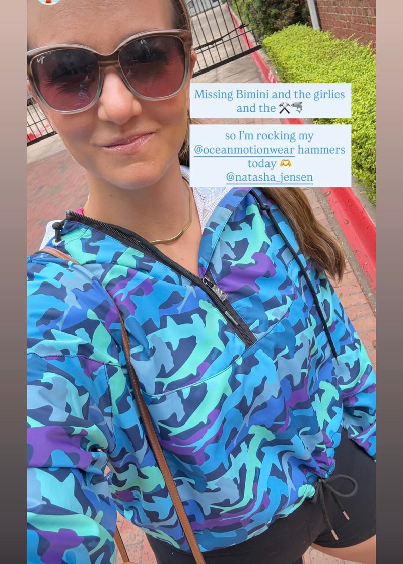 Woman wearing a colorful hammerhead patterned jacket with text overlay