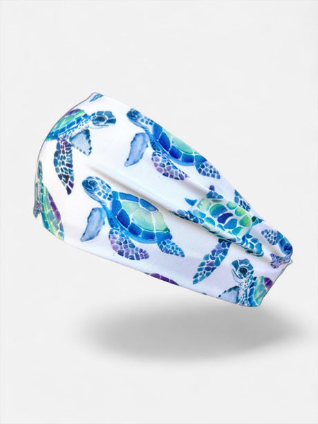 Headband with blue and green turtle pattern on a white background