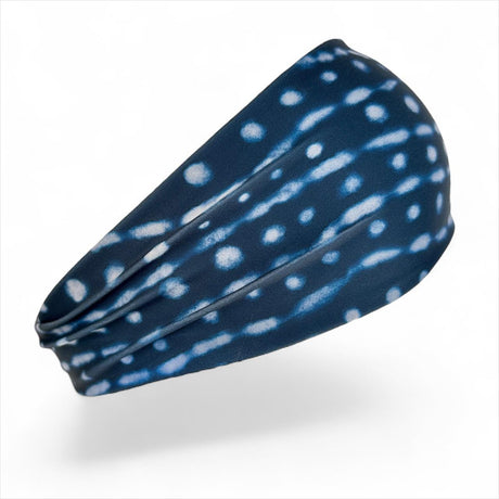 Navy blue headband with white polka dot pattern on a white background