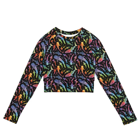 Ocean Motion Wear black long-sleeve crop rashguard with a vibrant rainbow shark pattern and UPF 50+ sun protection.
