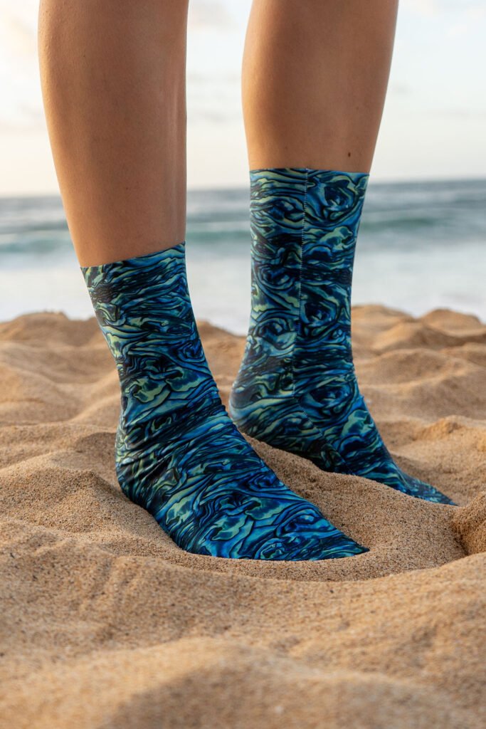 Person_wearing_patterned_socks_on_sand_1
